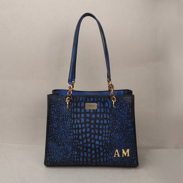 Customized Metal Initial Smokey Blue Deep Cut Croco Leather Button Closure Hand Bag for Ladies by Brune & Bareskin